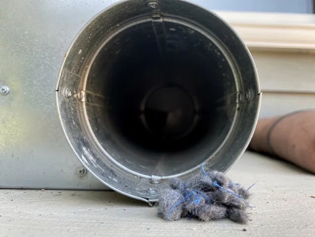 Grafton Dryer Vent Cleaning technician using specialized equipment to clear severe dryer vent blockage in Grafton